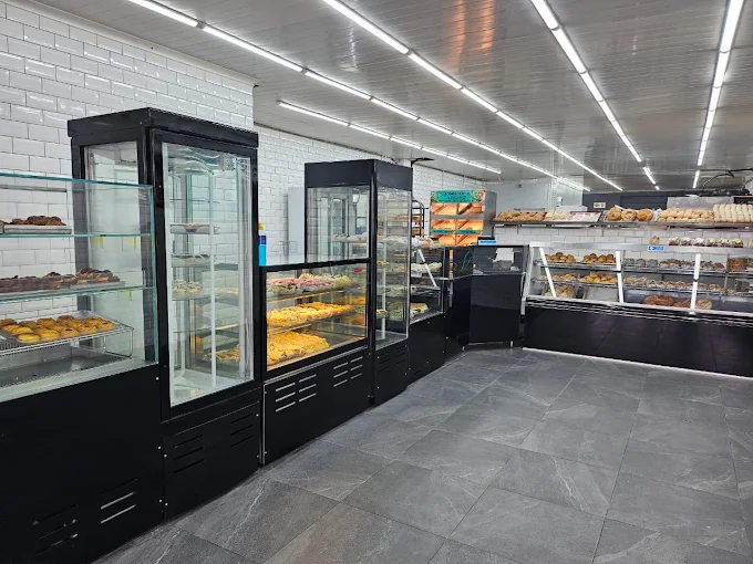 The bright, tiled interior of Bombalicious Bakes with fresh bakes on display